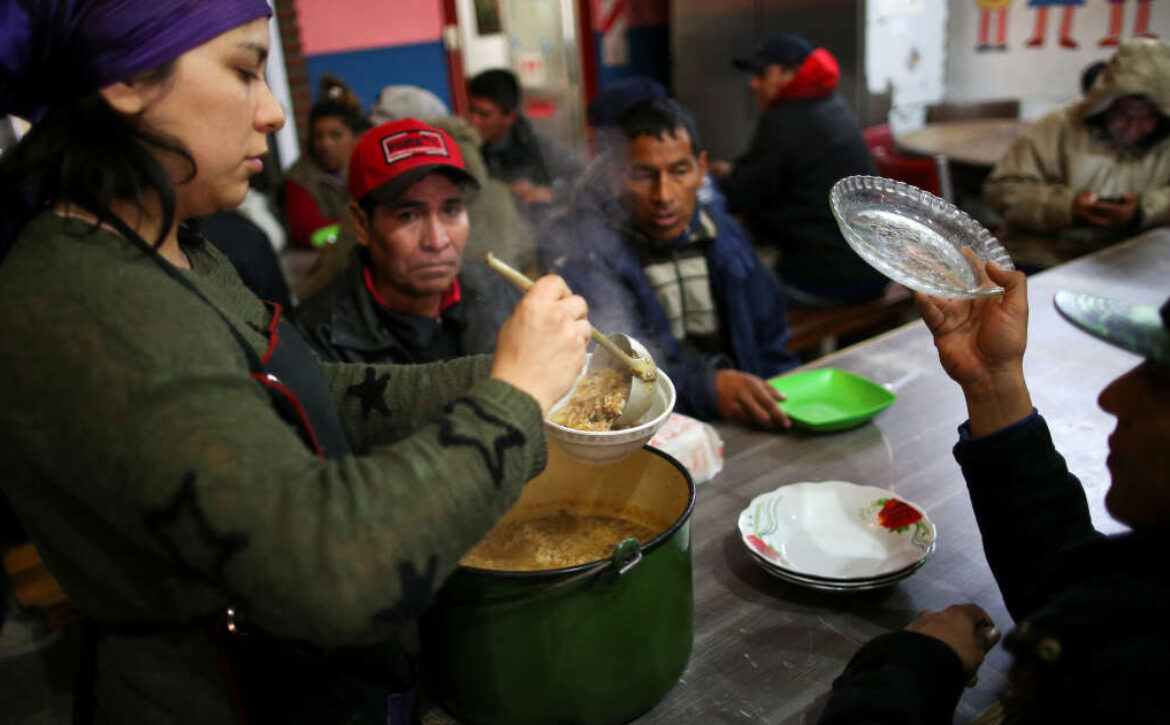 A volunteer serves stew at a soup kitchen in Buenos Aires