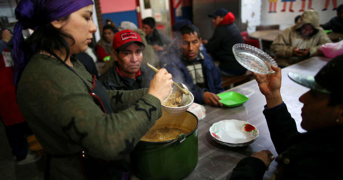 A volunteer serves stew at a soup kitchen in Buenos Aires